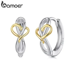 Bicolor Klappcreolen mit Herz & Unendlichkeit Symbol. Huggie Hoops Ohrringe aus 925 Silber mit goldenem Herzdetail für ewige Liebe.